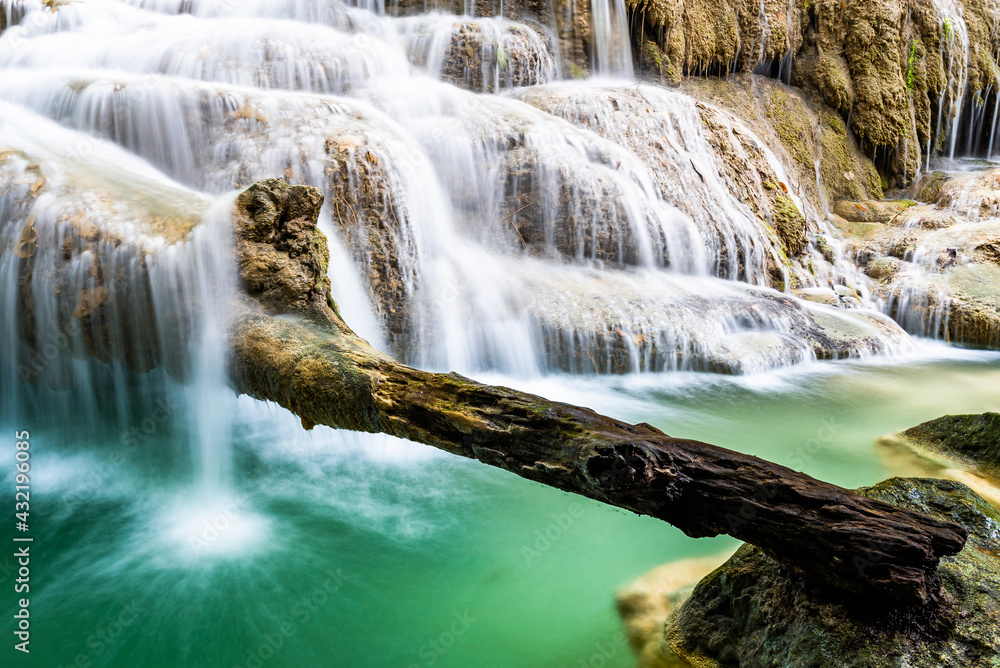Waterfall and blue emerald water color in Erawan national park. Erawan Waterfall, Beautiful nature rock waterfall steps in tropical rainforest at Kanchanaburi province, Thailand Waterfall and blue emerald water color in Erawan national park. Erawan Waterfall, Beautiful nature rock waterfall steps in tropical rainforest at Kanchanaburi province, Thailand
