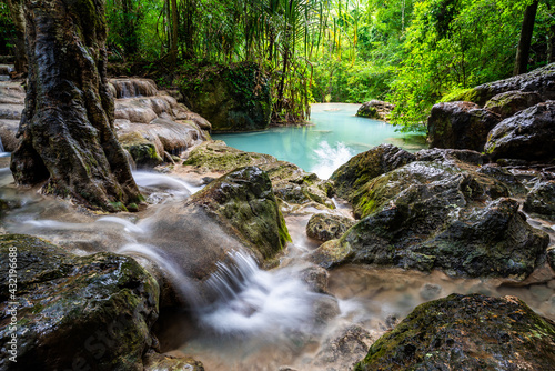 Waterfall and blue emerald water color in Erawan national park. Erawan Waterfall, Beautiful nature rock waterfall steps in tropical rainforest at Kanchanaburi province, Thailand