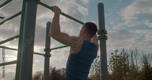 Athletic man doing strength training outdoors. Daily exercise to keep fit.