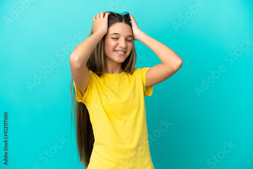 Little girl over isolated blue background laughing © luismolinero
