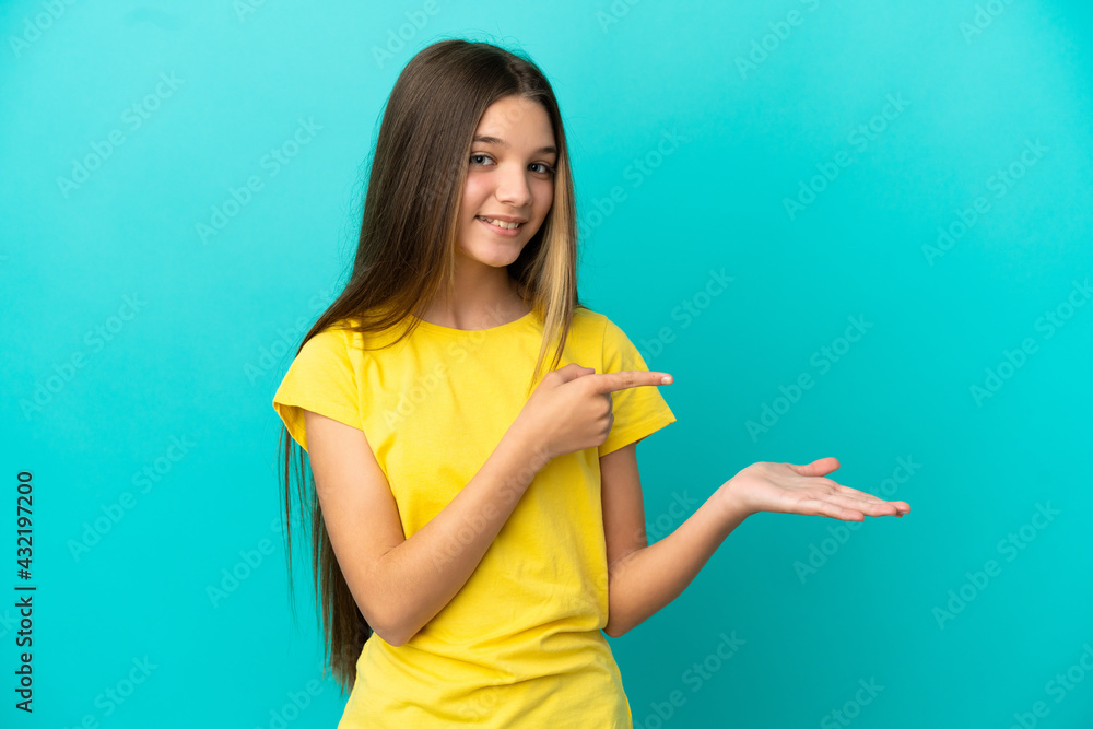 Little girl over isolated blue background holding copyspace imaginary on the palm to insert an ad Little girl over isolated blue background holding copyspace imaginary on the palm to insert an ad