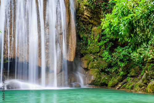 Waterfall and blue emerald water color in Erawan national park. Erawan Waterfall  Beautiful nature rock waterfall steps in tropical rainforest at Kanchanaburi province  Thailand