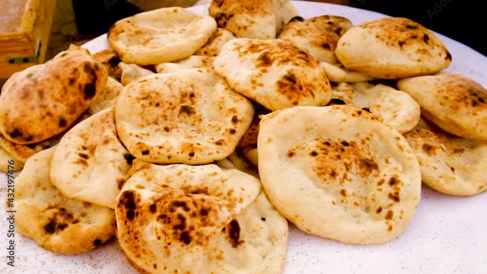 Cakes are baked in a tandoor. Selective focus. Cakes are baked in a tandoor. Selective focus.