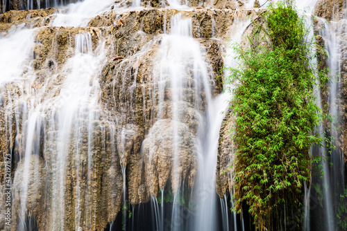 Waterfall and blue emerald water color in Erawan national park. Erawan Waterfall, Beautiful nature rock waterfall steps in tropical rainforest at Kanchanaburi province, Thailand