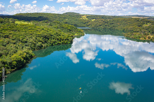 Partial landscape with reflections in the water, seen over the Pontilhao de Uberlândia, over the waters of the Araguari River, Municipality of Uberlândia State of Minas Gerai, Brazil
