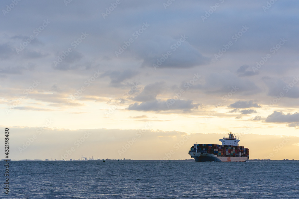 sunset behind a Cargo ship
