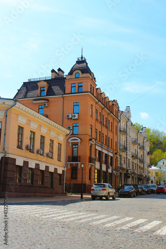 Road, pedestrian crossing, beautiful historic buildings in the center, typical European facades. cityscape with pedestrian crossing road.