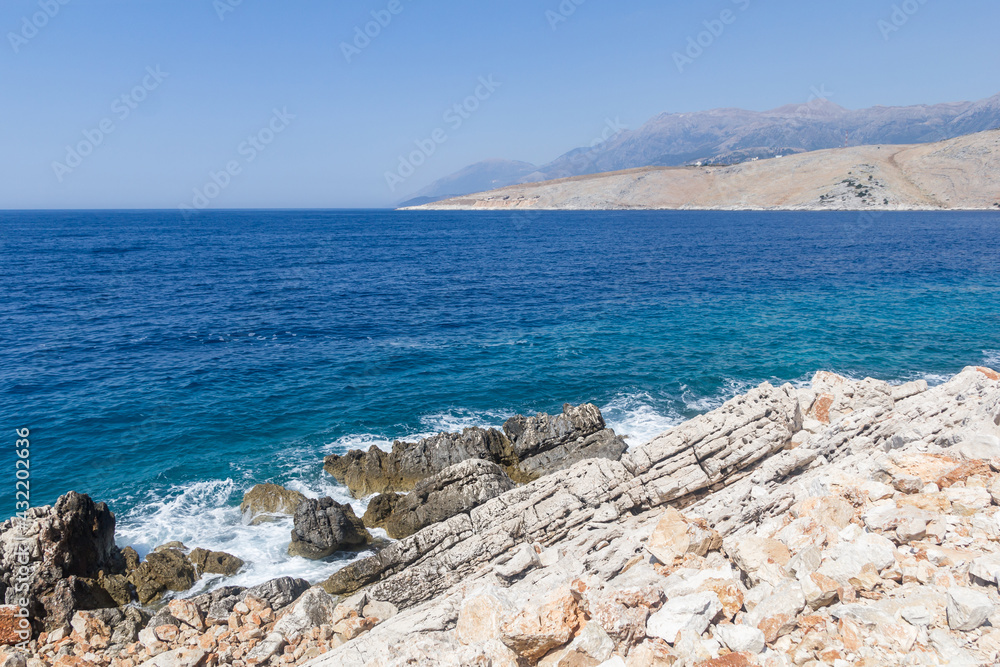 Rocks and turquoise sea, Albania. Travel theme, beautiful nature.