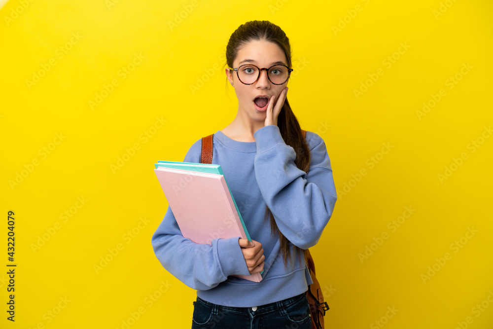 Student kid woman over isolated yellow background with surprise and shocked facial expression Student kid woman over isolated yellow background with surprise and shocked facial expression