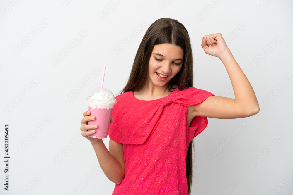 Little girl with strawberry milkshake over isolated white background celebrating a victory