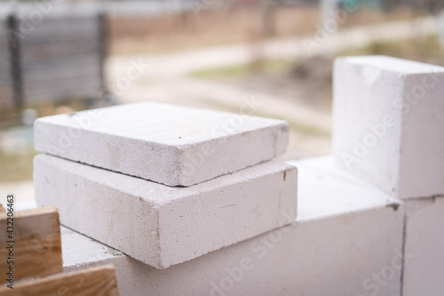 Cut-to-size aerated concrete blocks lie at the construction site photo