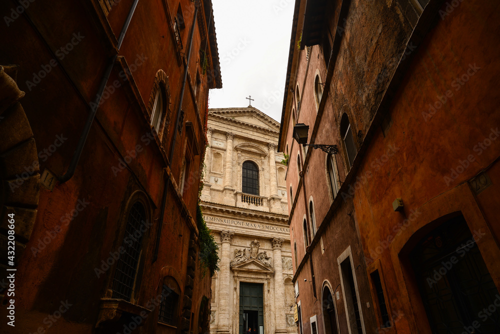 Detail of the facade of the Basilica of San Giovanni dei Fiorentini at the end of a narrow street in central Rome, Italy