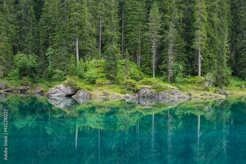 Reflection in the crystal clear Lago di Carezza, Italy photo