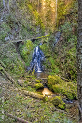 Lotenbachklamm Waterfall with a wooden bridge in the Wutach Gorge, in the Black Forest, Southwest Germany