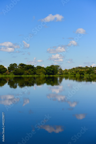 Cloud reflections on a tranquil Guaporé - Itenez river near Mateguá village, Beni Department, Bolivia, on the border with Rondonia state, Brazil photo