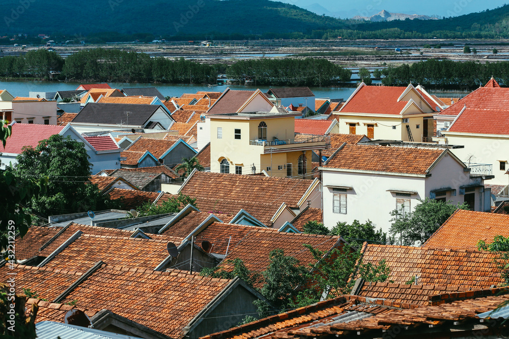 A view of a small country town with traditional houses with orange roofs in Vietnam