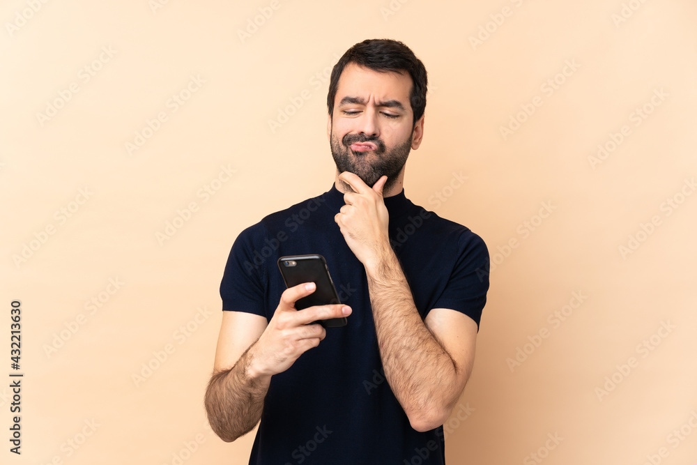 Caucasian handsome man over isolated background thinking and sending a message Caucasian handsome man over isolated background thinking and sending a message