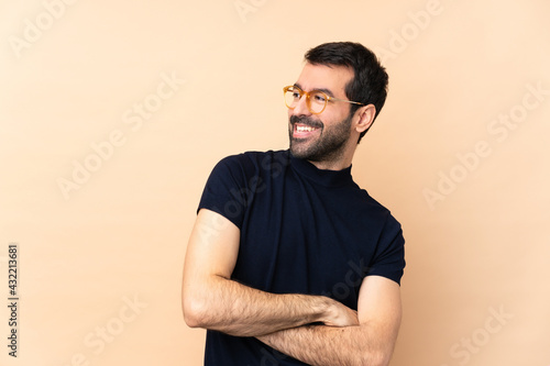 Caucasian handsome man over isolated background with glasses and smiling