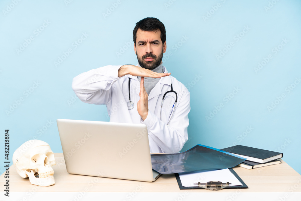 Professional traumatologist in workplace making time out gesture Professional traumatologist in workplace making time out gesture