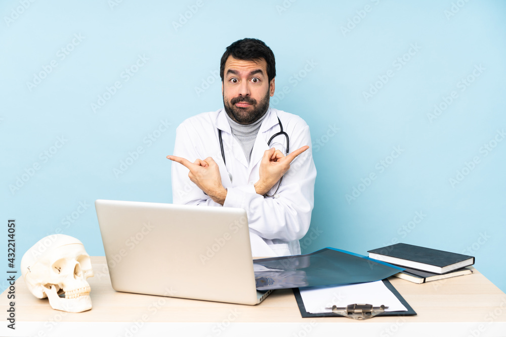 Professional traumatologist in workplace pointing to the laterals having doubts