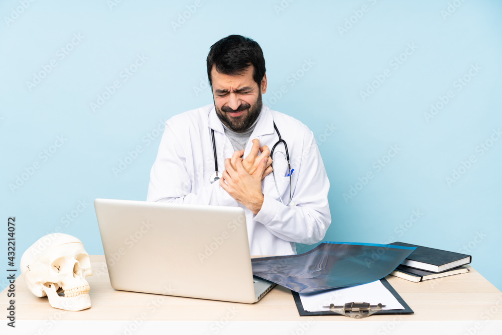 Professional traumatologist in workplace having a pain in the heart Professional traumatologist in workplace having a pain in the heart