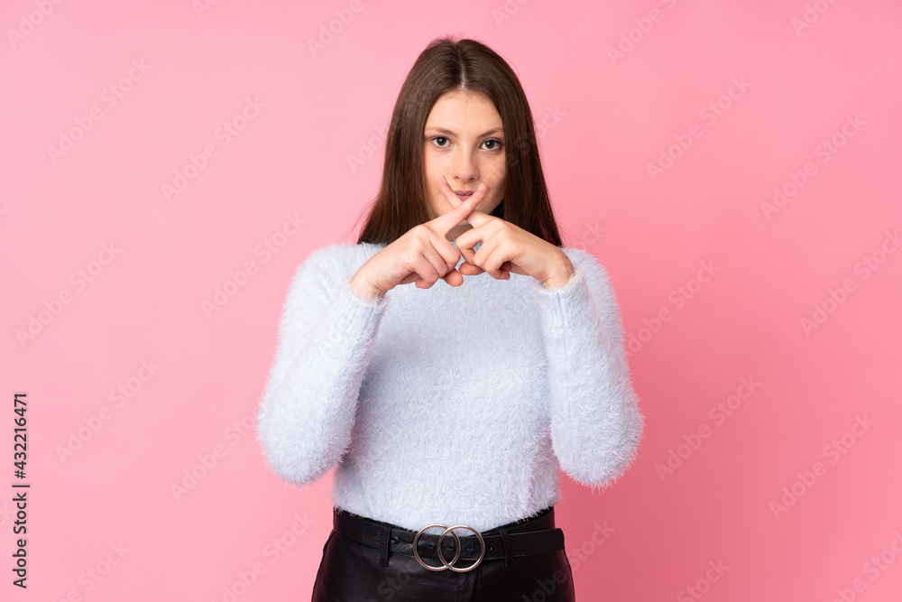 Teenager caucasian girl isolated on pink background showing a sign of silence gesture Teenager caucasian girl isolated on pink background showing a sign of silence gesture