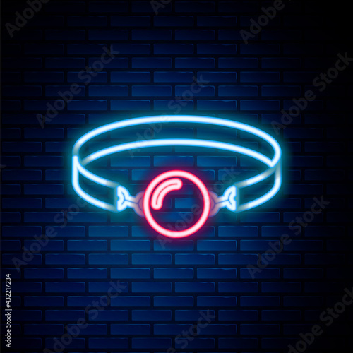 Glowing neon line Silicone ball gag with a leather belt icon isolated on brick wall background. Fetish accessory. Sex toy for men and woman. Colorful outline concept. Vector