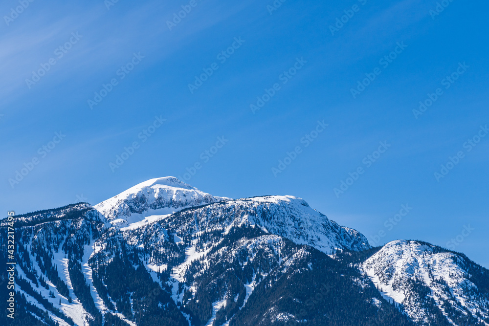 Beautiful snow-capped Columbia Mountains against the blue sky in British Columbia Canada