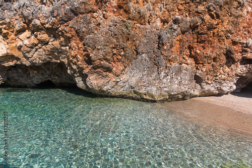 Amazing turquoise sea, wild beach and rocks surrounded by vegetation, Albania. Travel and vacation theme