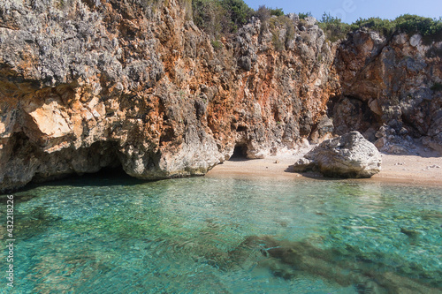 Amazing turquoise sea, wild beach and rocks surrounded by vegetation, Albania. Travel and vacation theme