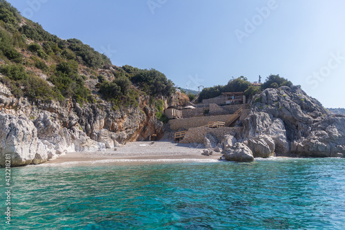 View of the strip of the sea, small beach and mountains surrounded by vegetation, Albania. Travel and vacation theme