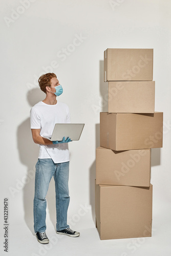 Picture of a redhead deliveryman counting his packages 
