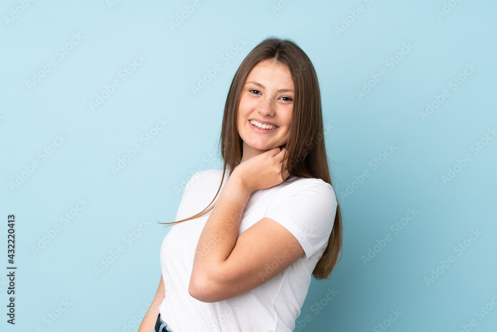 Teenager caucasian girl isolated on blue background laughing Teenager caucasian girl isolated on blue background laughing