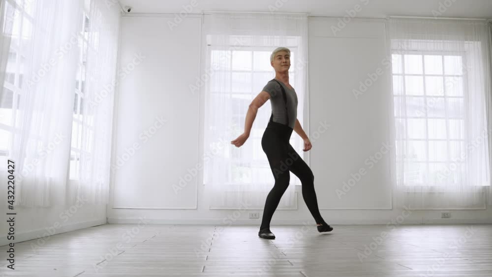 young Asian ballet dancer practicing in a room alone.
young Asian ballet dancer practicing in a room alone.