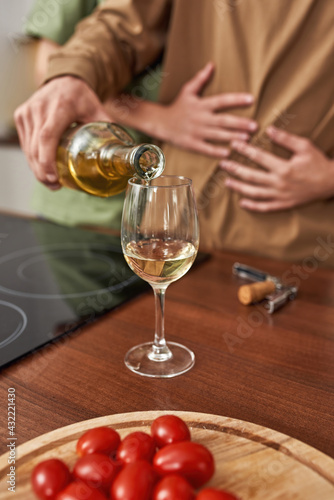 Selective focus on man pouring wine into glass