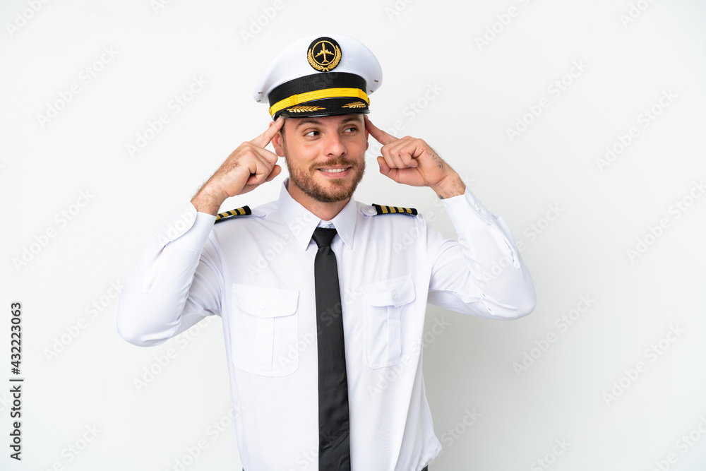 Airplane Brazilian pilot isolated on white background having doubts and thinking Airplane Brazilian pilot isolated on white background having doubts and thinking