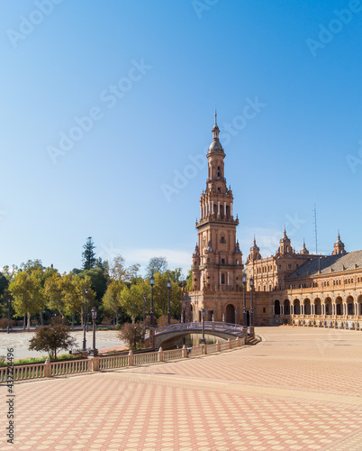 North tower of the Plaza de Espana in Seville (Andalusia, Spain). View of the square and the pedestrian bridge that crosses the estuary. Emblematic monumental building and main tourist attraction.