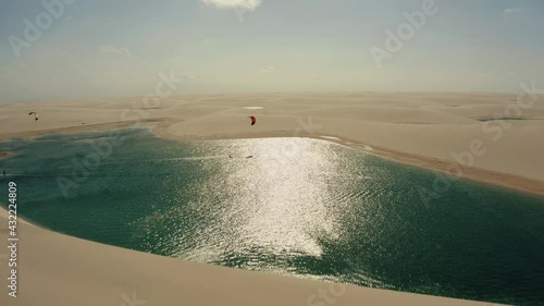 Lencois Maranhenses kitesurfer lagoon dunes paradise desert water sports aerial view panorama drone 4k Brazil