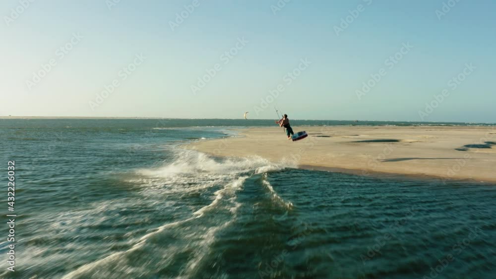 kitesurfer jumping over beach aerial drone following water sports travel tourism summer brazil atins 4k