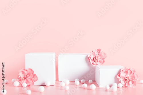 White empty stands decorated  flowers on beige background. © photopixel