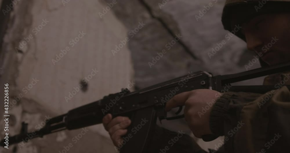 The terrorist shoots from the AK-47 automatic machine. Concept: terrorist attack, study, army. The terrorist shoots from the AK-47 automatic machine. Concept: terrorist attack, study, army.