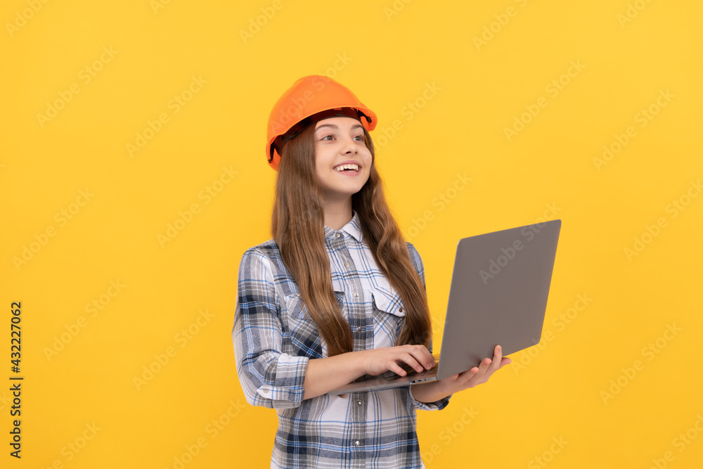 happy teen girl in helmet and checkered shirt using laptop, school happy teen girl in helmet and checkered shirt using laptop, school