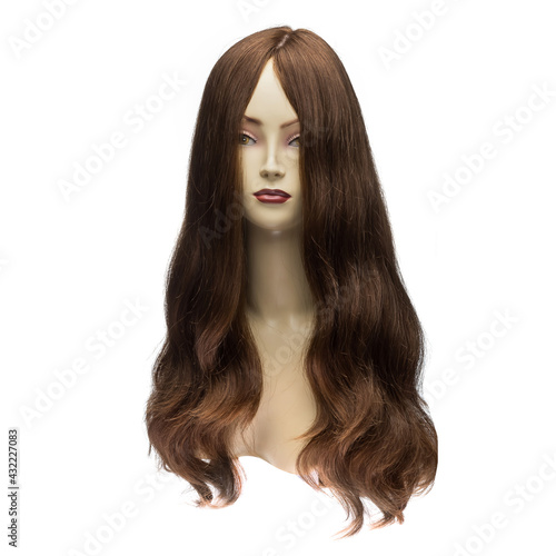 Human hair wig on a mannequin. Front view. Brunette. Straight hair