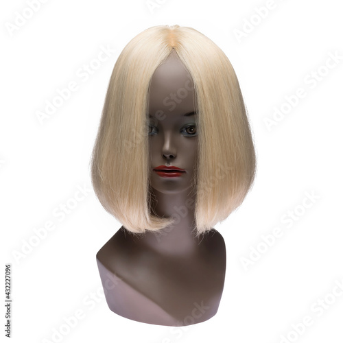 Human hair wig on a mannequin. Front view. Blonde. Straight hair