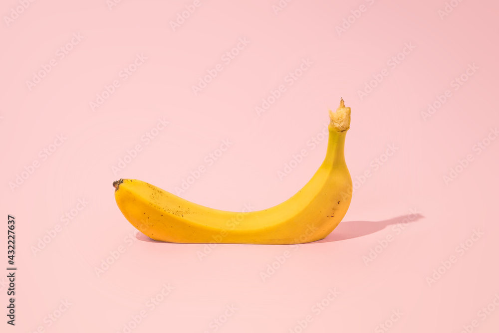 Cutted Banana On A Pink Background. MInimal creativ summer concept.