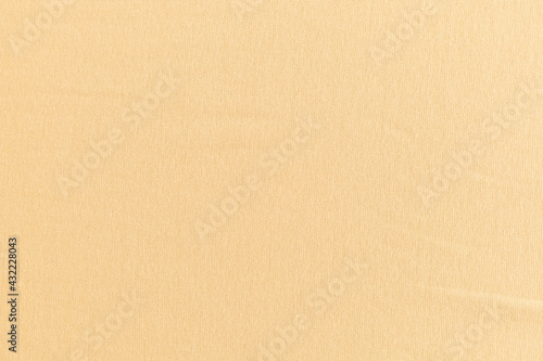 smooth surface of soft knitted fabric for sewing clothes in cream color, background, texture