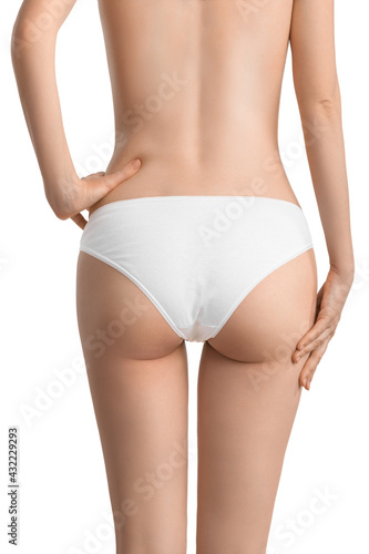 A slender girl in classic white underwear shows off her waist and toned buttocks. The concept of diet, exercise, body care or getting rid of cellulite © Александр Маликов
