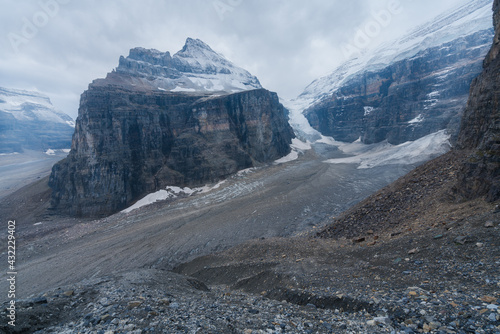 View of the Victoria glacier in the mist at the end of Plain of Six Glacier trail, Banff National Park, Alberta, Canada, on a cold and cloudy day. Hiking Canadian Rockies. photo