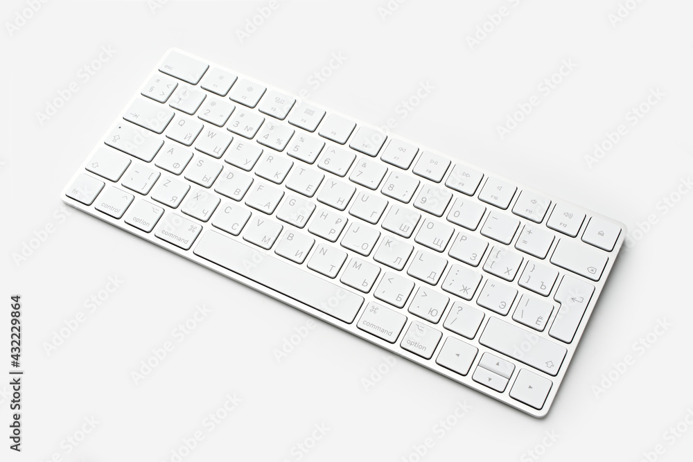 White wireless computer keyboard isolated on white background. Russian / English keyboard layout White wireless computer keyboard isolated on white background. Russian / English keyboard layout