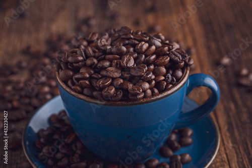 warm coffee and beans on wooden background